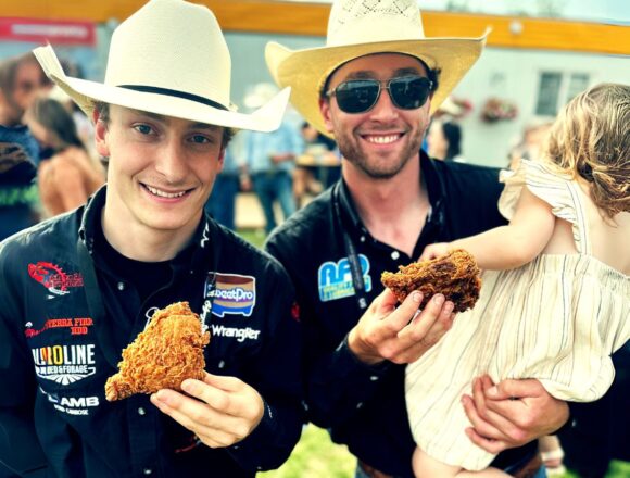 Fried chicken at calgary stamepede eaten by two rodeo riders